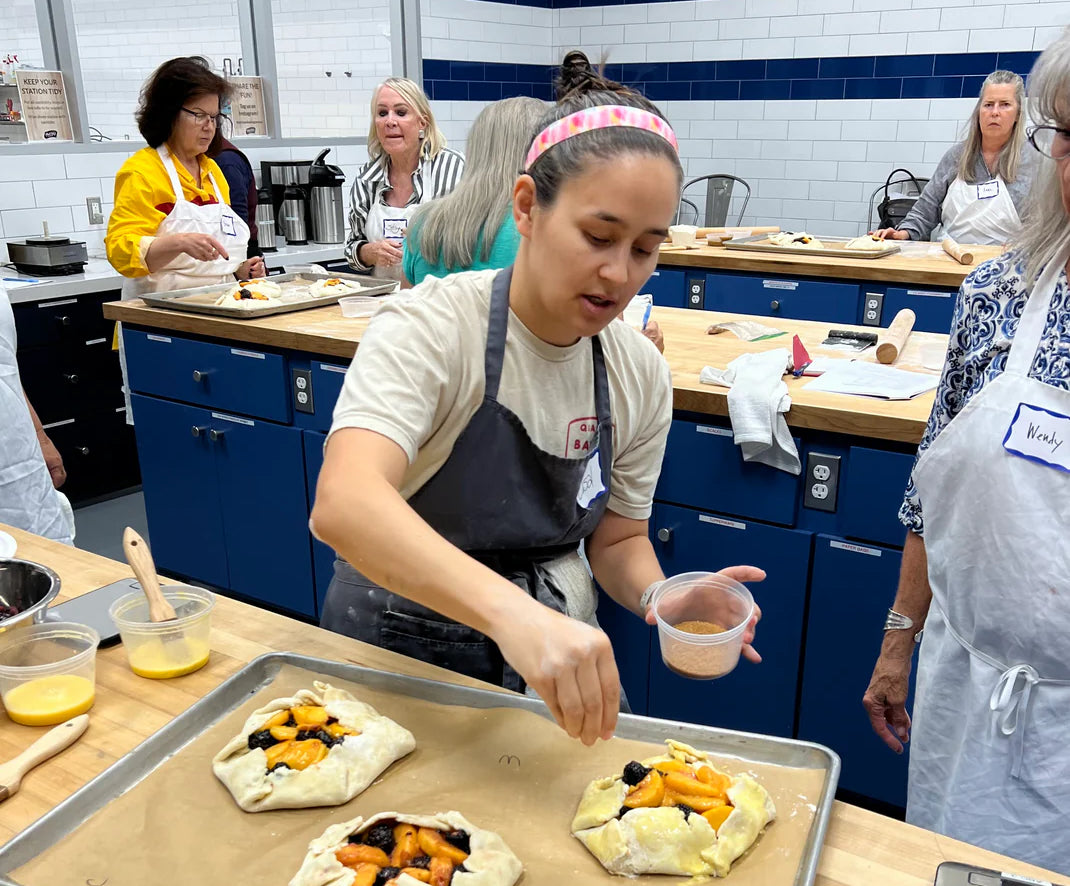 Lisal leading a baking class, sharing her passion for artisan croissants and pastries.